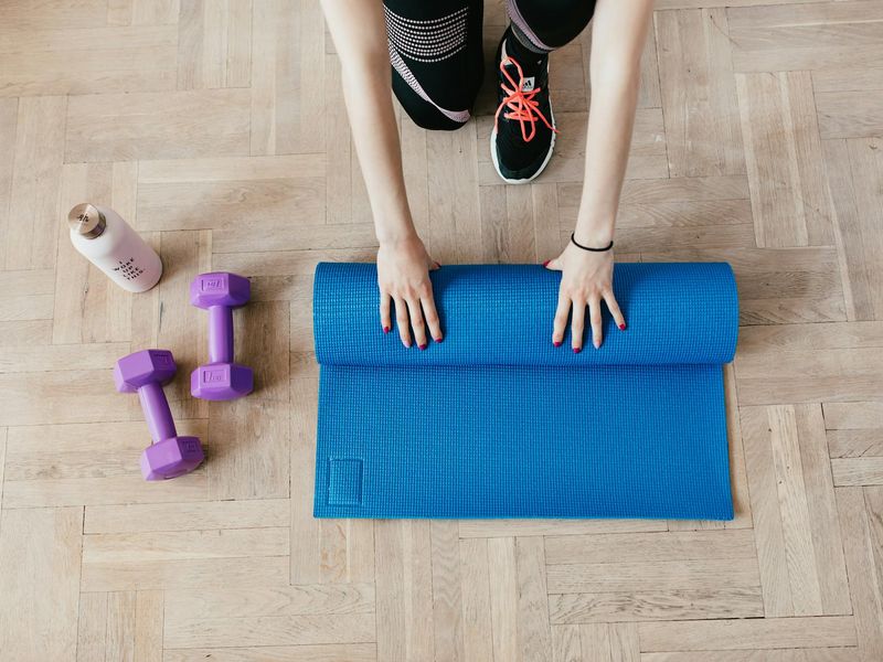 Top view of exercise equipment on a clean wooden floor.